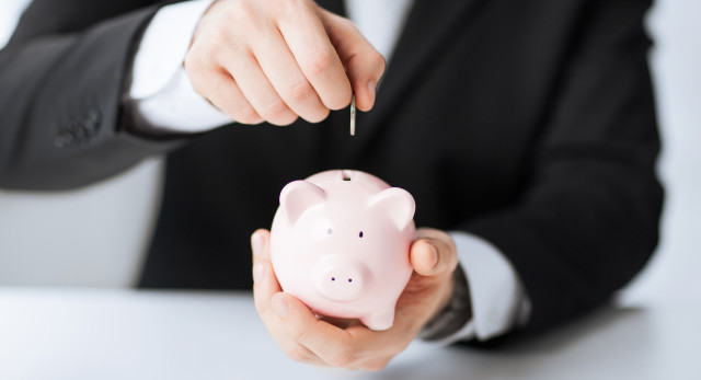 picture-of-man-putting-coin-into-small-piggy-bank-2